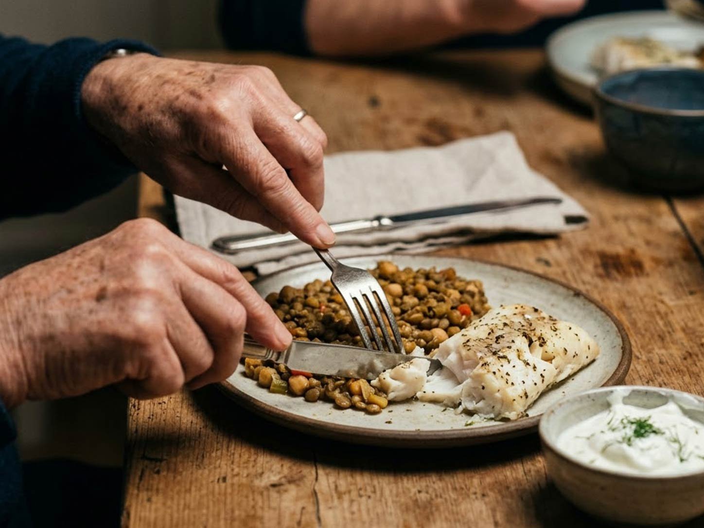 A protein-rich shared meal, elder's hands prominent