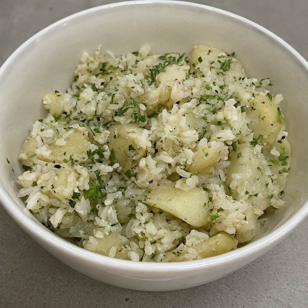 A bowl of cooked-then-cooled rice with fresh herbs