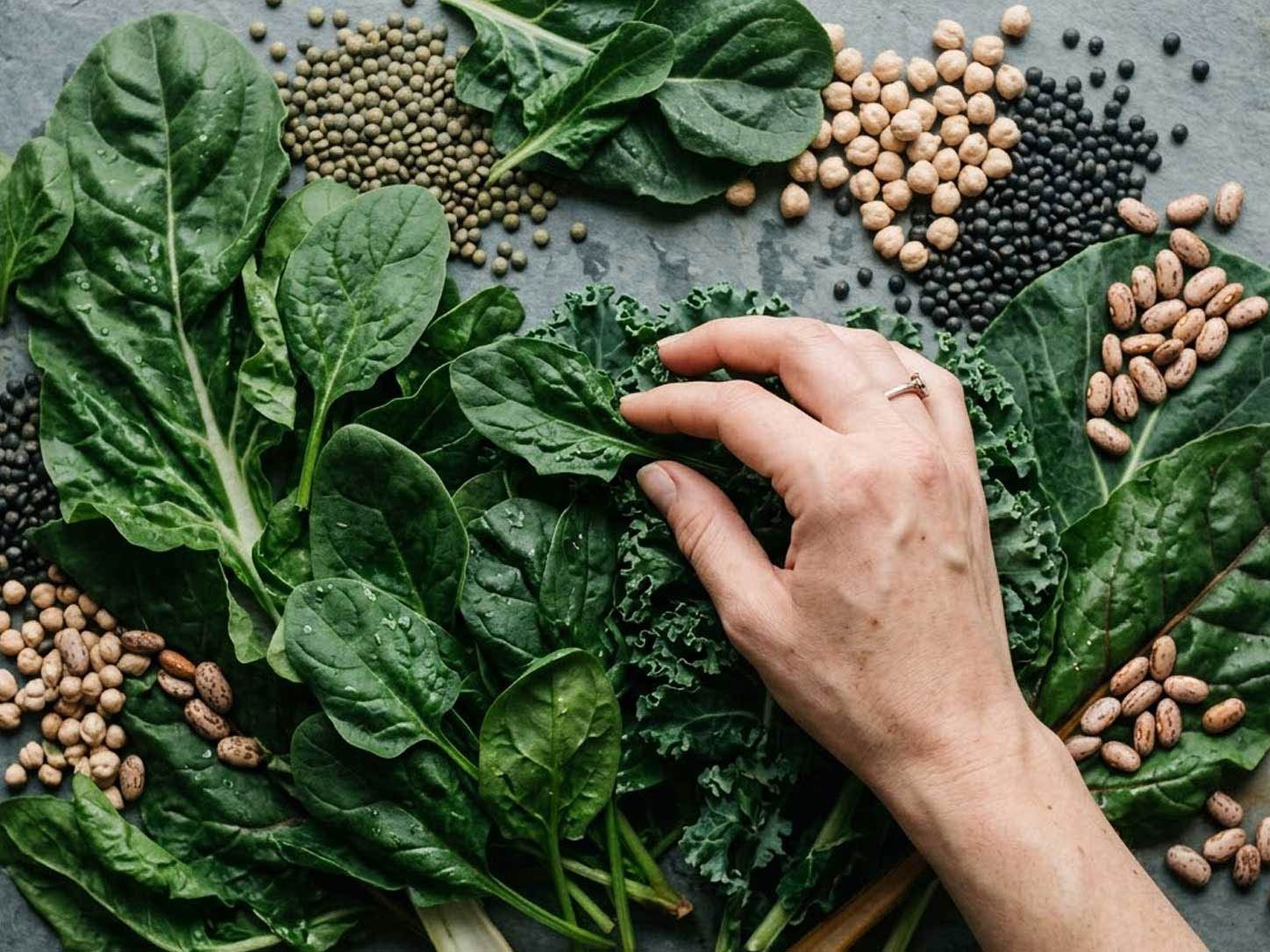Dark leafy greens and legumes in a fresh flat lay